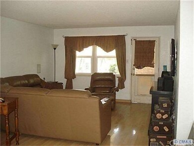 Warm and cozy living room that leads to a lush bac