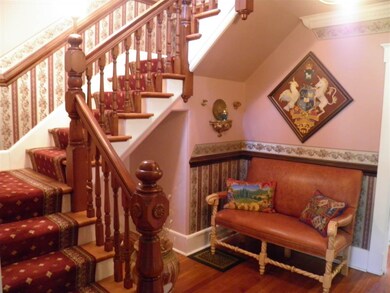 Welcoming front hallway with splendid staircase to