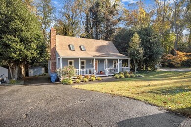 New england style home with a storage shed and cov