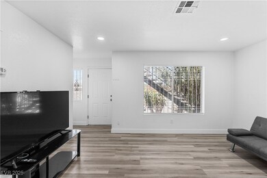 Living area with plenty of natural light, finished floors, recessed lighting, and baseboards