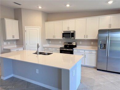 Kitchen featuring stainless steel appliances, a si