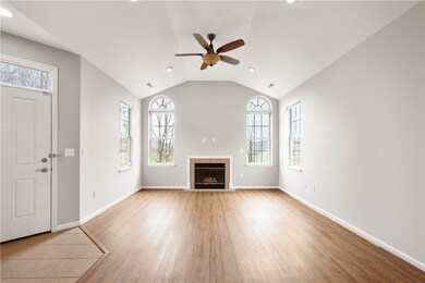 STATELY WINDOWS FLANK THE GAS FIREPLACE.