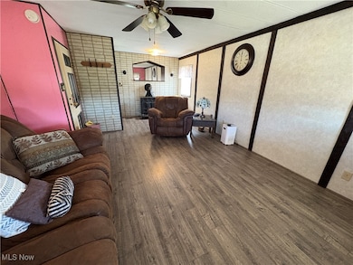 Living area featuring wood finished floors and ceiling fan