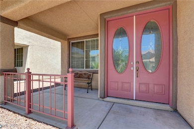 Front glass double doors and cozy porch.