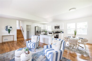 Living area featuring stairs, light wood-style flo