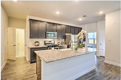 Kitchen featuring stainless steel appliances, lig