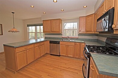 Eat-in kitchen features a gas range.