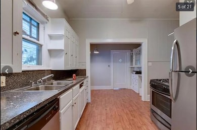 Kitchen with stainless steel appliances, white ca