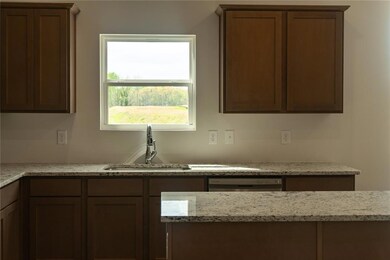 Kitchen with stainless steel dishwasher, a sink, a