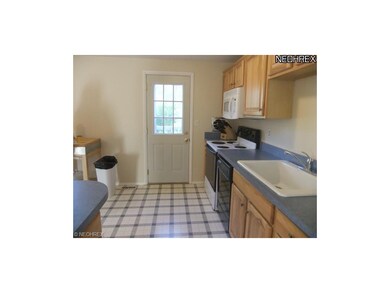 The kitchen features access to the deck and backya