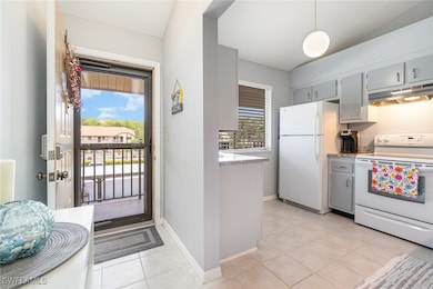 Kitchen with white appliances, under cabinet range