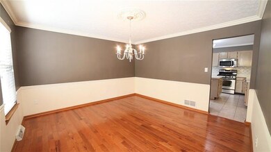 Well appointed dining room with handsome trim, two toned paint, gleaming floors, open to the kitchen.