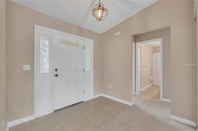 Entryway with new porcelain tile and fresh paint throughout home
