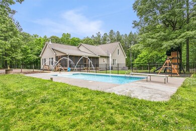View of pool featuring a playground, a yard, and a