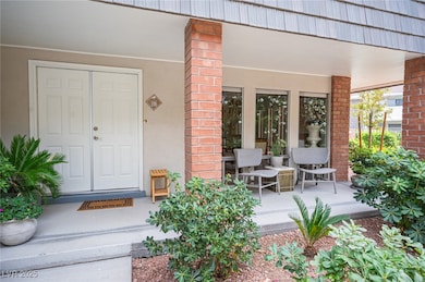 Doorway to property with a porch, stucco siding, a