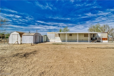 Back of house featuring a storage shed, a patio, a