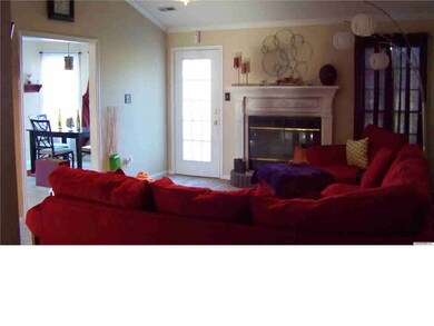 Comfortable livingroom with vaulted ceiling, gas log fireplace and tv.