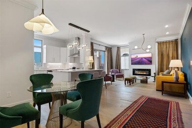 Dining area with light hardwood / wood-style floors, crown molding, and a notable chandelier