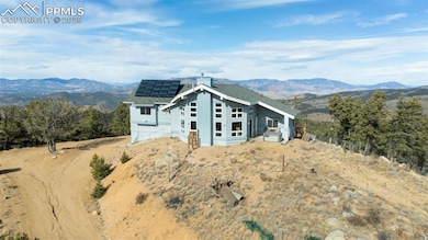 Property under construction with a mountain view, stucco siding, and solar panels