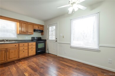 Kitchen with sink, dark hardwood / wood-style floo