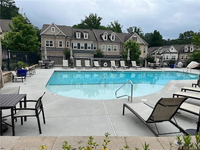 Community pool with a residential view and a patio area