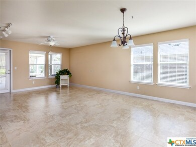 From the entrance to the flex room, you can see the generous dining and living spaces.