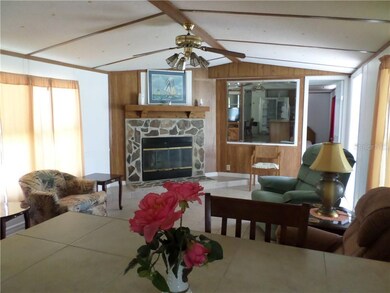 LIVING ROOM WITH FIREPLACE AND TILE FLOORING