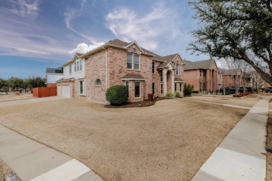 View of front of house with driveway, brick siding