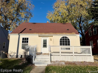 Back of property with a deck and a chimney