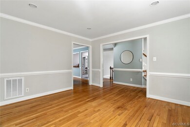 Empty room with crown molding and light hardwood f