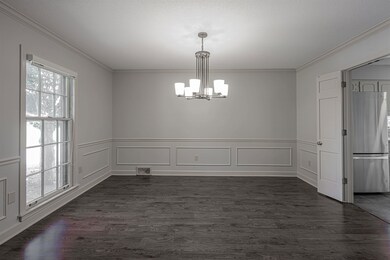 Unfurnished dining area with a notable chandelier,