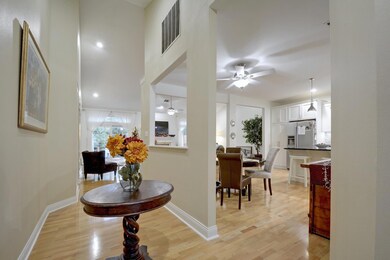 Hallway with light wood-style floors and baseboar