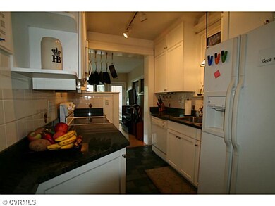Kitchen - White cabinets to the ceiling, granite c