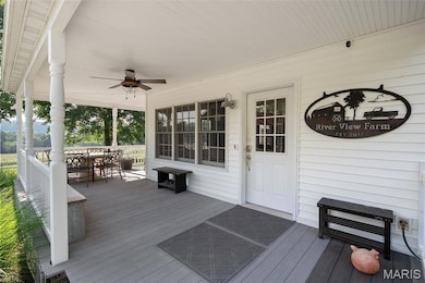 Porch featuring outdoor dining space and ceiling fan
