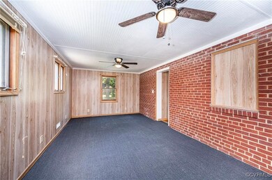Spare room featuring ornamental molding, wood wall
