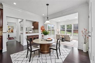 Dining room with ornamental molding, baseboards, d