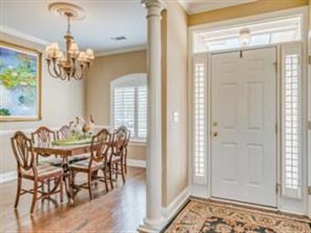 Hickory wood floors flow from the entry foyer into