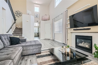 Living room with light wood finished floors, stair