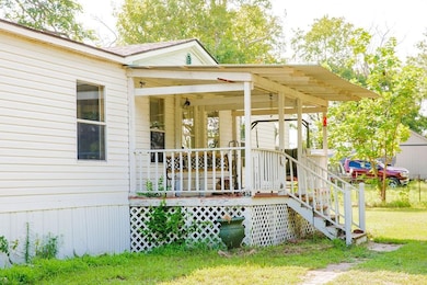 View of exterior entry with covered porch and a ya