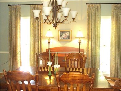 Large Dining Room with custom window treatments. Room for the holiday/family gatherings.