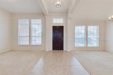 The entry features gorgeous windows, a mahogany front door, double crown molding and set the tone for this open and bright home.