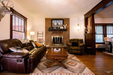 Living area featuring wood finished floors and a brick fireplace