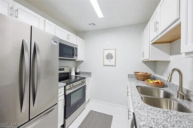 Kitchen with baseboards, visible vents, a sink, st