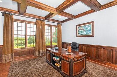 Office with coffered ceiling and paneled walls