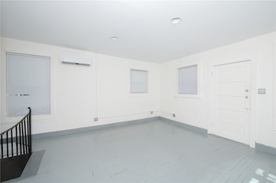 Empty room with wood finished floors, baseboards,