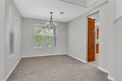 Formal dining room overlooks backyard & pool.