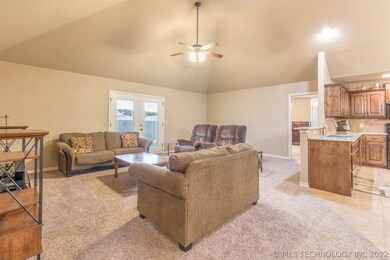 Living room has vaulted ceilings with ceiling fan/