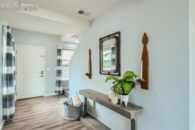 Welcoming entry area with laminate floors and wide