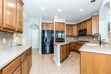 Large kitchen with island, updated appliances, double ovens  and plenty of storage.