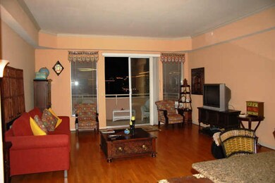 Main living area with hardwood flooring, high ceil